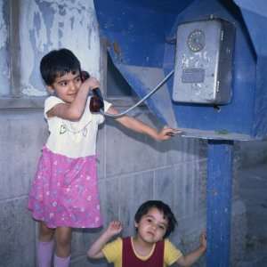  Small Uzbek Girls Using the Public Telephone in Bukhara, Uzbekistan 