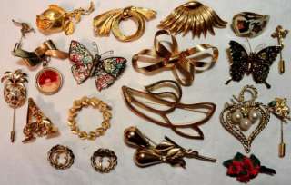   is a large lot of vintage brooches scarp slides and clips dress clips