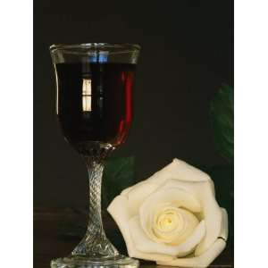  Close View of a White Rose Placed Beside a Glass of Red 